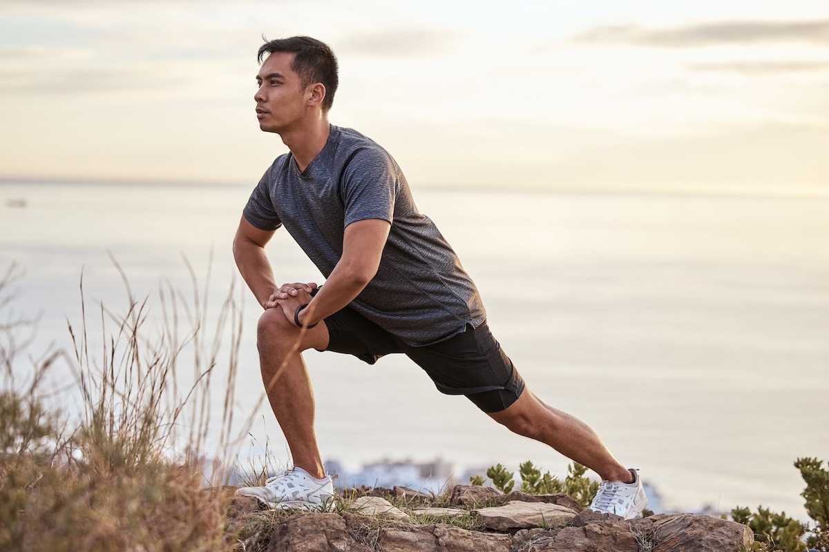 Shot of a young man exercising in nature. - reduce stress