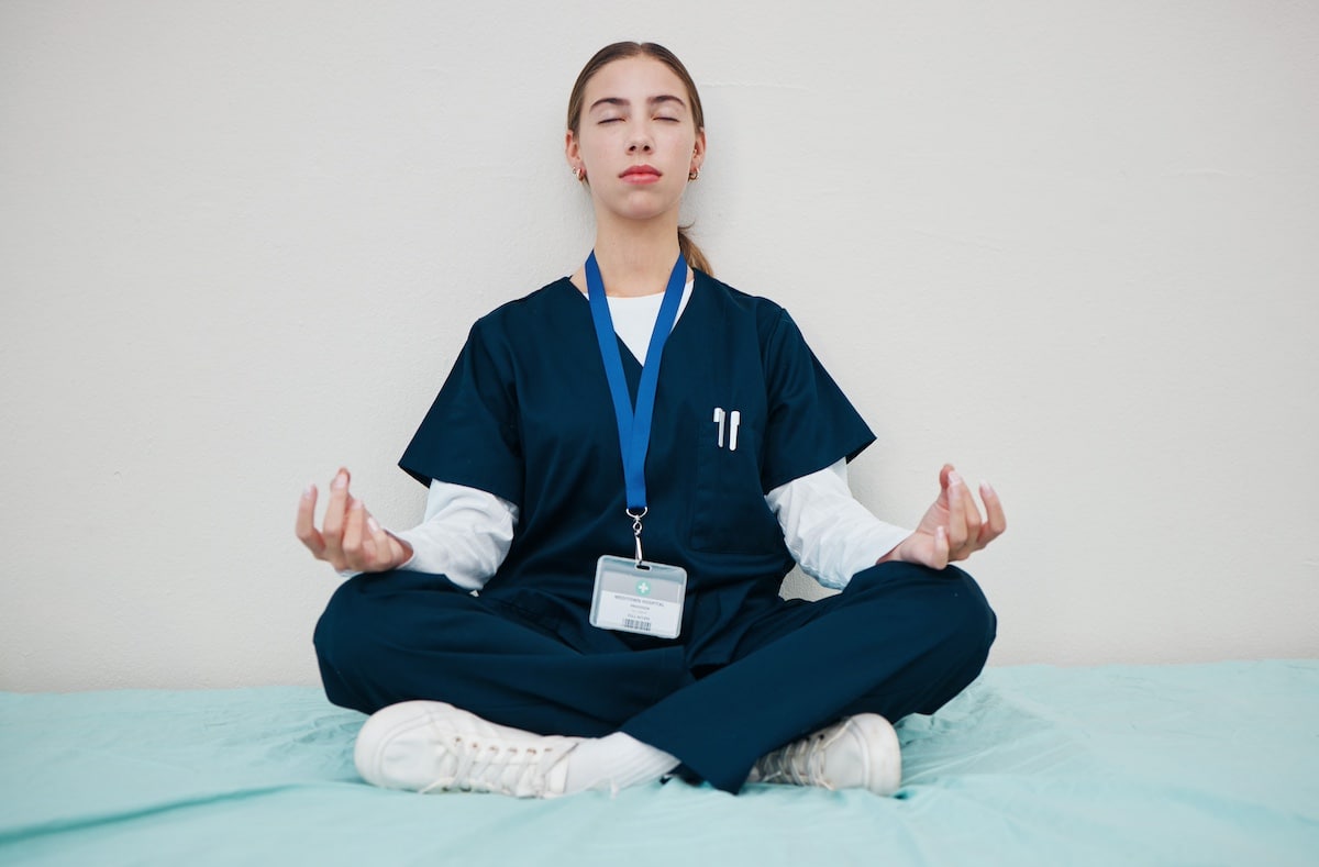 Woman, nurse and meditate to relax in hospital, healing and break from work, yoga and calm for mental health. Medical professional, peace and wellness for aura, zen and chakra for balance in career. - reduce stress