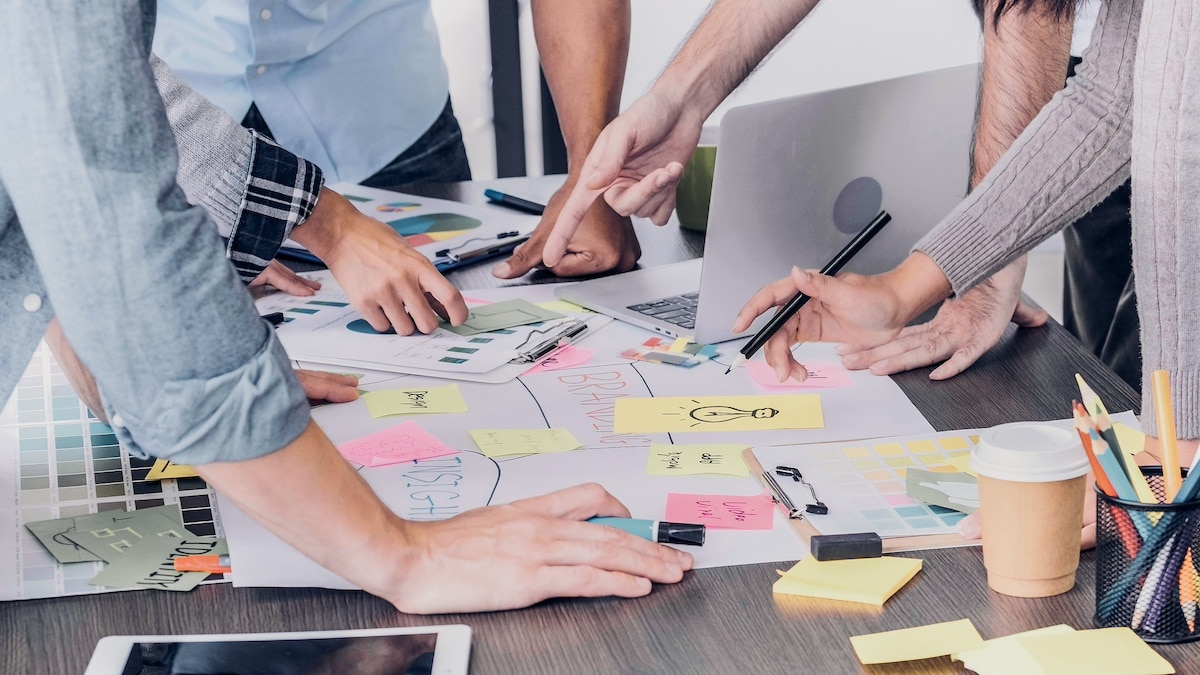 Close up creative designer applaud for job success at meeting table at office -